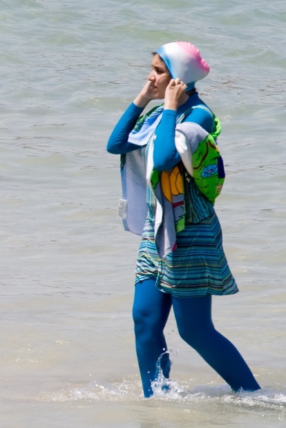 A woman in a burkini on the beach
