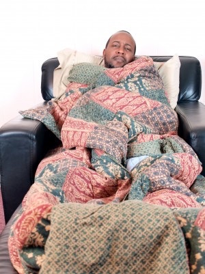 A man tightly wrapped in blankets