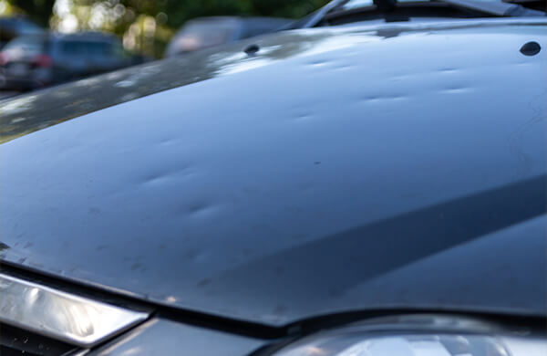 Dings from hail on a car hood