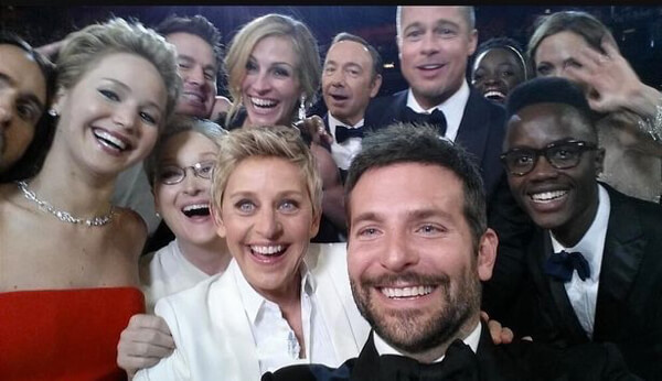 Ellen DeGeneres and a group of celebrities taking a grelfie at the Academy Awards