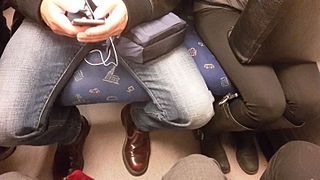 A guy manspreading next to a woman