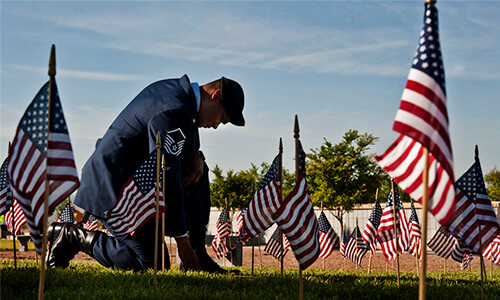 An Air Force vet placing flags at a memorial